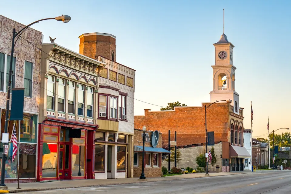 Commercial street in small rural U.S. town with storefronts and clocktower.